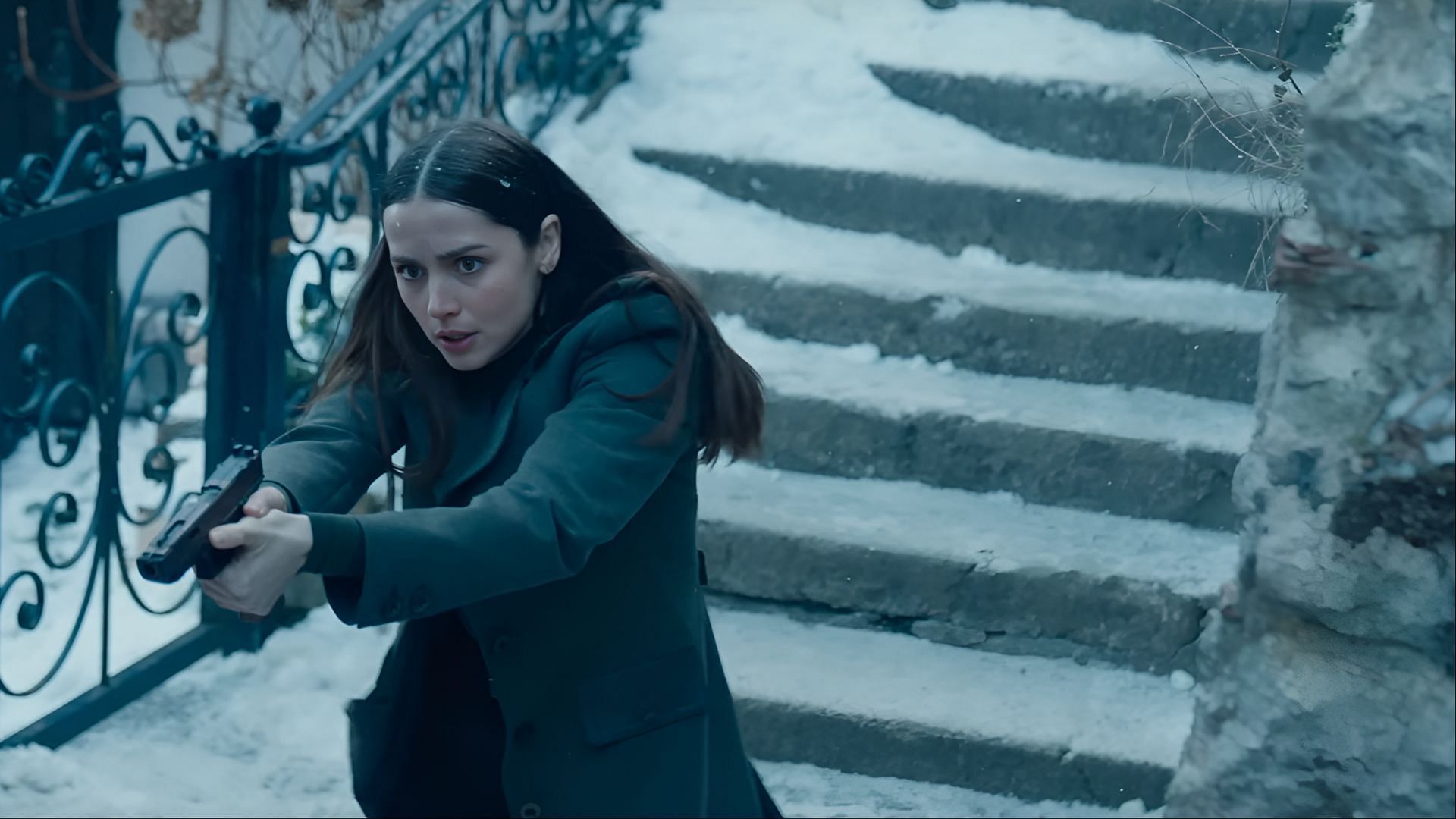 Eve Macarro prepares to engage in a snowy confrontation while a tense track from the Ballerina soundtrack builds suspense in the background. (Image via Lionsgate)